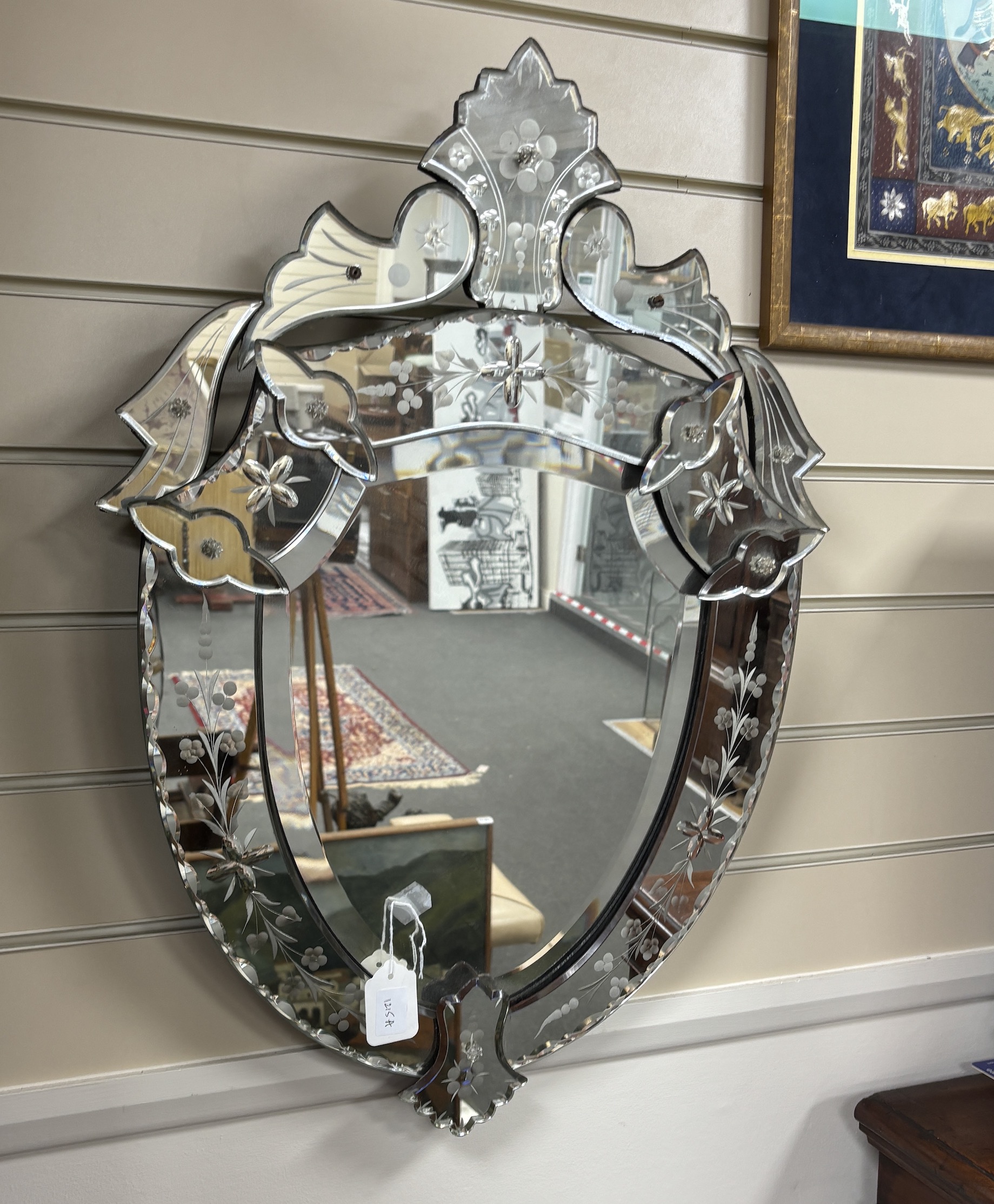 A Venetian shield shaped wall mirror, width 50cm, height 70cm